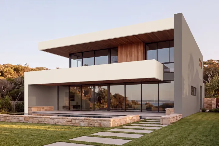 The home with the tall end wall and terrace wall in Dulux Reckless Grey and the bands in Hog Bristle Quarter.