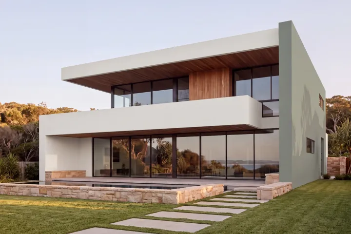 The home in Colorbond Surfmist with the tall end wall in Dulux Misty Moss.